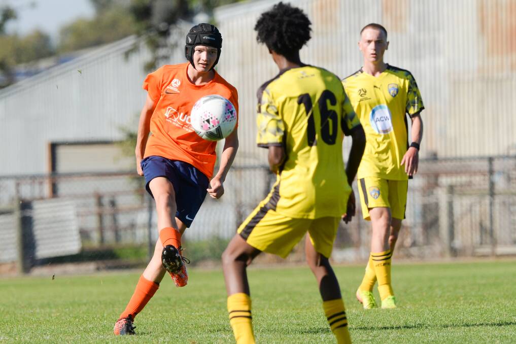 Bendigo City under-17s defender Jacob Floyd chips the ball over a Werribee City opponent. Picture: DARREN HOWE