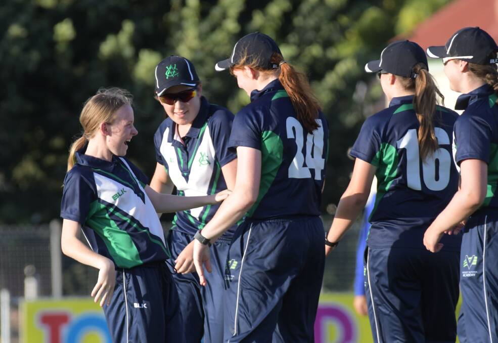 Letesha Bawden is congratulated by her team-mates after snaring one of her three wickets against WA. Picture: NONI HYETT