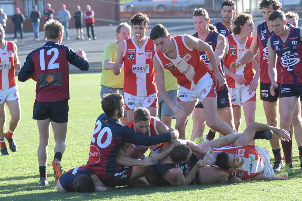 SPITEFUL: Sandhurst and South Bendigo players tangle after Dragons' midfielder Lee Coghlan copped a high tackle from Bloods' coach Brady Childs. Picture: NONI HYETT