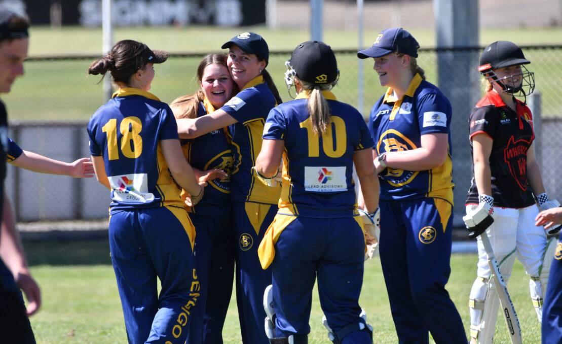 Bendigo team-mates congratulate Holly Ryan after she took three wickets in an over. Picture by Adam Bourke