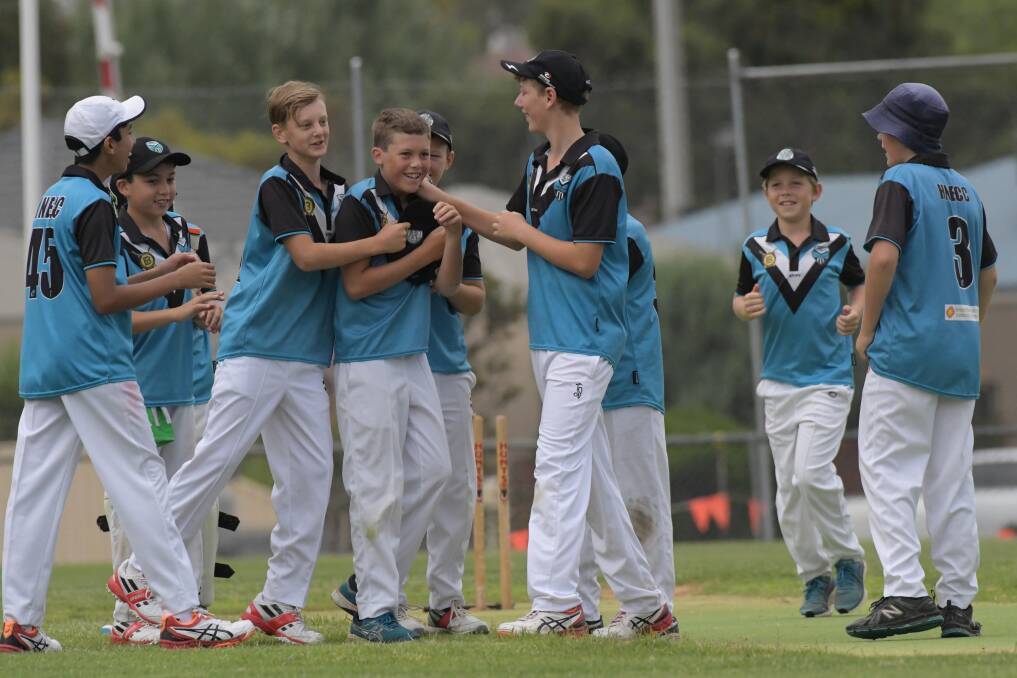 WELL DONE, MATE: Huntly-North Epsom players congratulate Tom Miller after he took a wicket. Picture: NONI HYETT