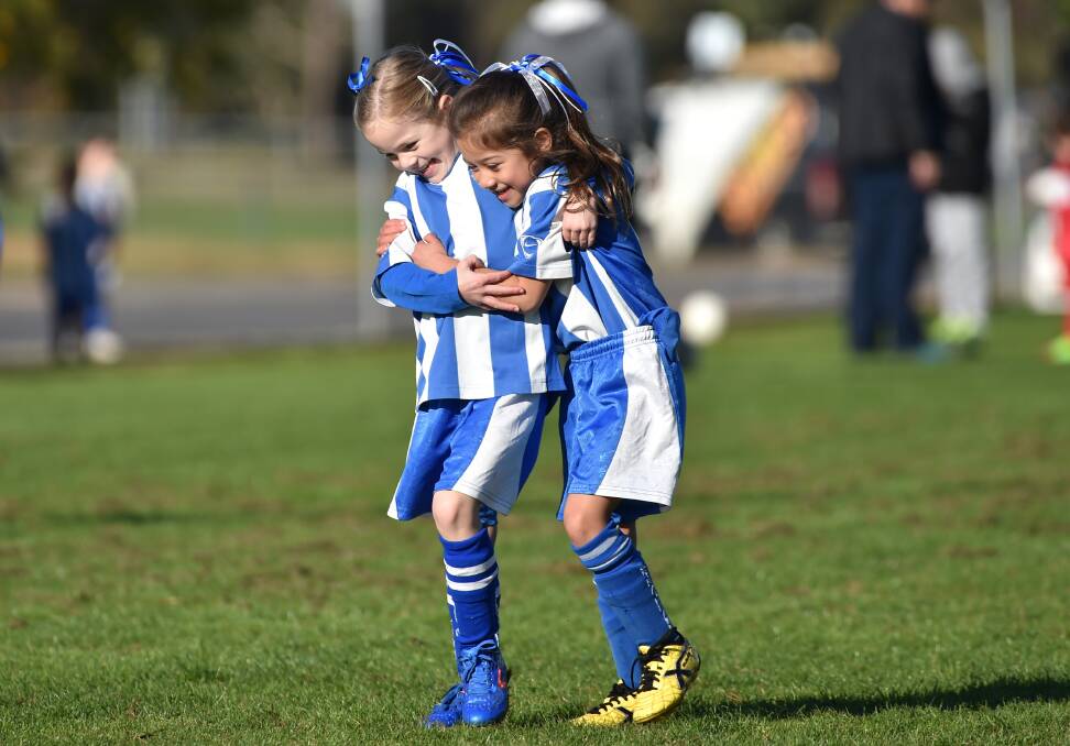Strathdale under-6 players Sophie Pedrotti and Sophia Caruana give each other a cuddle during their game with Epsom. Picture: GLENN DANIELS