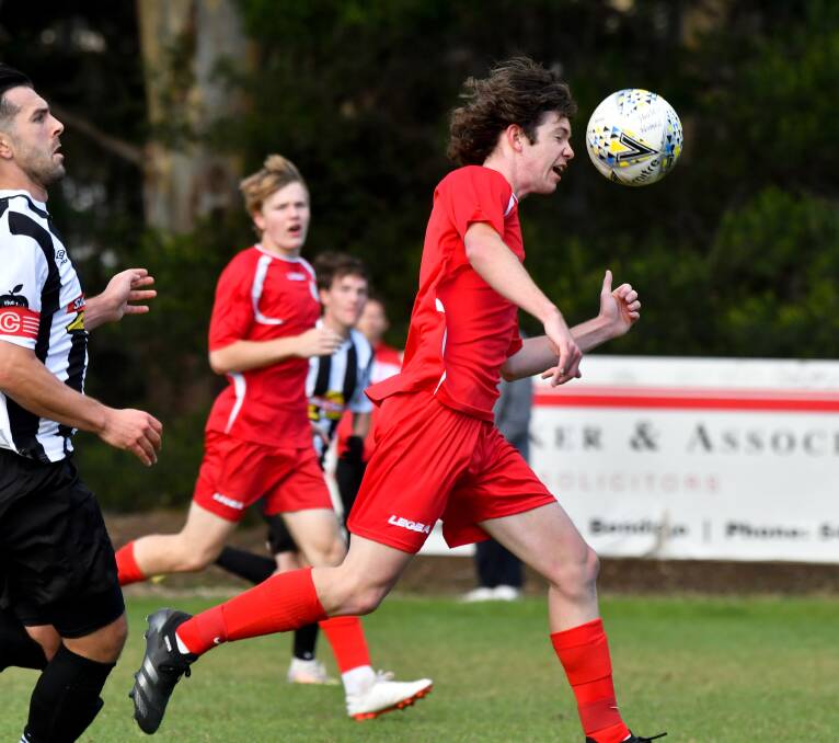 HEAD FIRST: Spring Gully United's Reece Yarwood wins the ball against Shepparton South on Sunday. Pictures: NONI HYETT