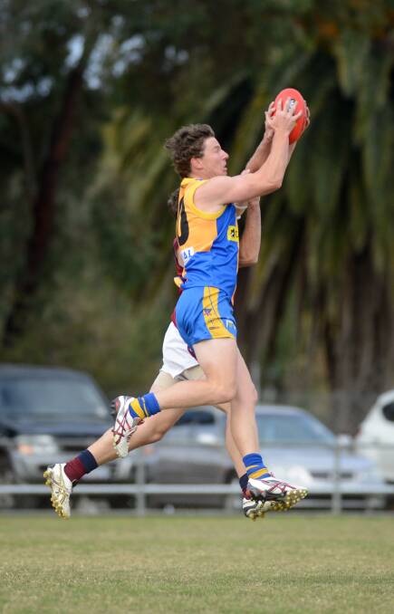 Grant Weeks takes one of his 11 marks against Sandhurst in round five, 2012.