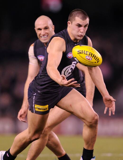 Jaryd Cachia alongside Chris Judd against St Kilda in 2013. Picture: THE AGE