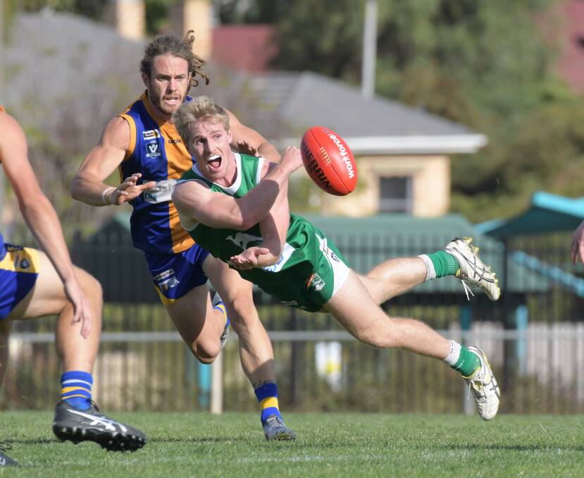Jonathan Lanyon fires out a handball during his playing days with Kangaroo Flat in the BFNL. Picture: NONI HYETT