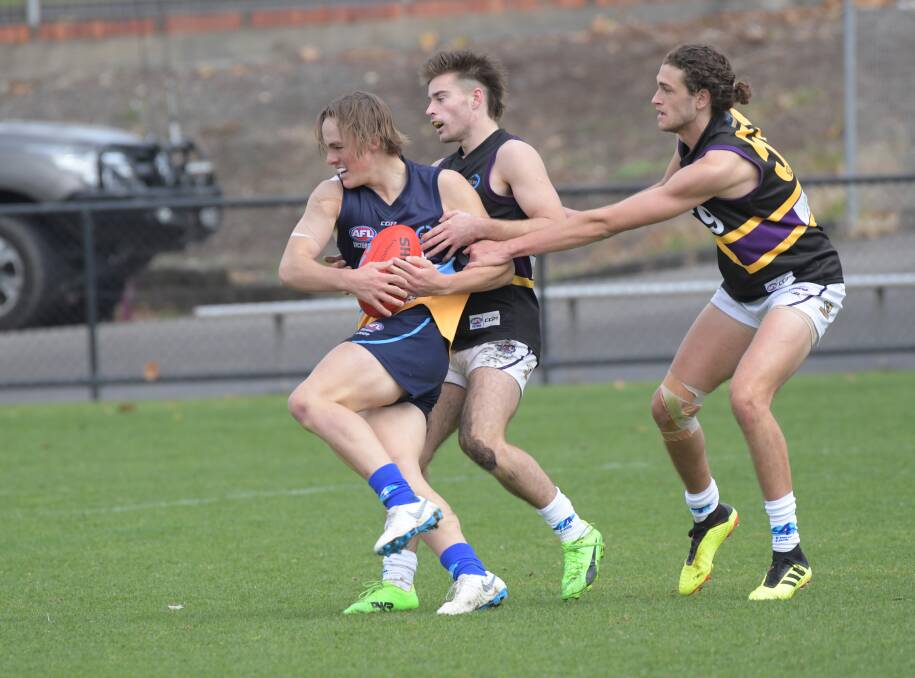 TWO ON ONE: Bendigo Pioneers' midfielder Zane Keighran takes on two Murray Bushrangers' opponents in Sunday's TAC Cup clash at the QEO. Picture: NONI HYETT