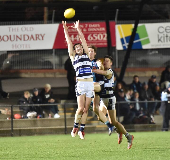 Lachie Ratcliffe floats back to take a gutsy mark in defence. Picture: GLENN DANIELS