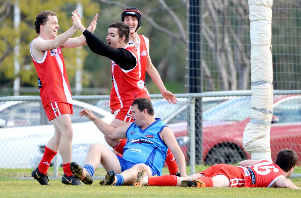 PARTY TIME: Bendigo team-mates Eamon Gleeson, Cooper Manton and Will Dohnt celebrate a goal. Picture: DARREN HOWE