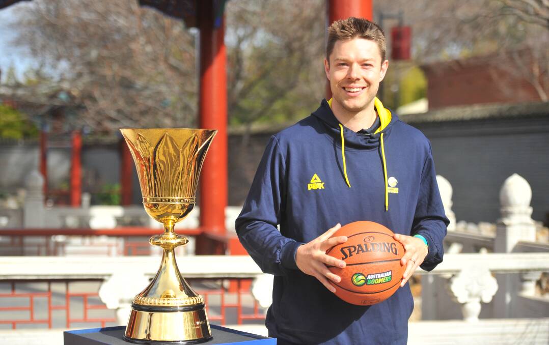Maryborough's Matthew Dellavedova with the FIBA World Cup Trophy at the Bendigo Chinese Gardens. Picture: ADAM BOURKE