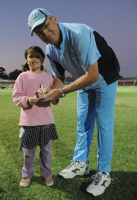 Dean Jones signs an autograph for a young fan at the QEO.