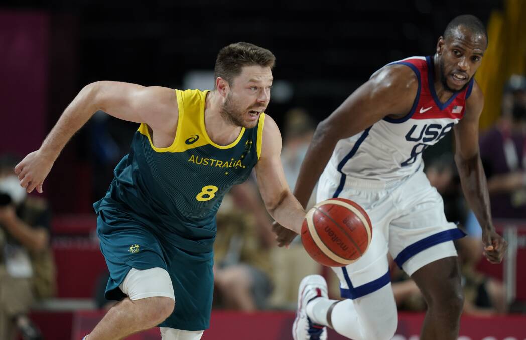 FROM TOKYO TO MELBOURNE: Matthew Dellavedova in action for the Boomers against the United States at the Olympics. The 30-year-old is back in Australia to play in the NBL. Picture: AAP