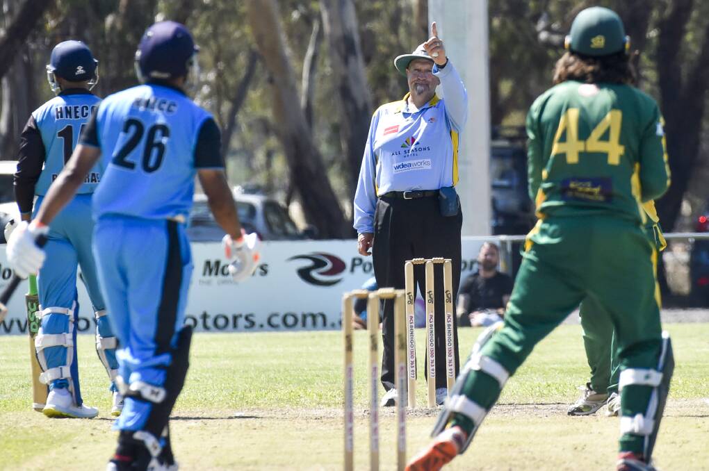 THAT'S OUT: Umpire Paul Martin raises his finger to indicate the dismissal of Huntly-North Epsom's Pathum De Mel. Picture: DARREN HOWE