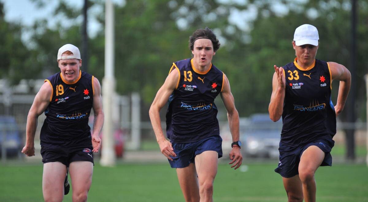Noah Walsh, Jack Evans and Jack Ginnivan work hard on the track. Picture: ADAM BOURKE