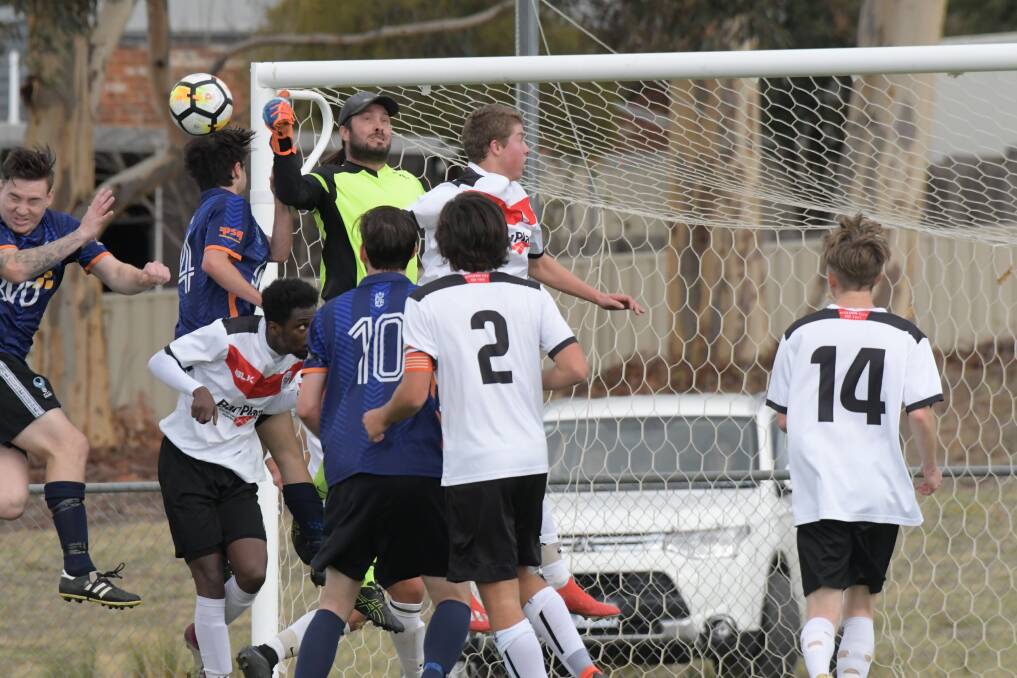 A scramble for possession in front of Eaglehawk's goal against Golden City.