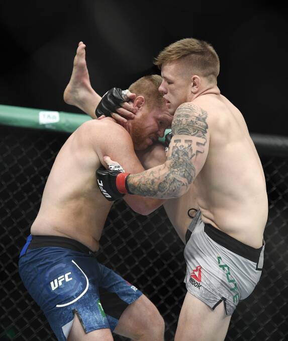 Jimmy Crute attempts to kick Sam Alvey. Picture: AAP