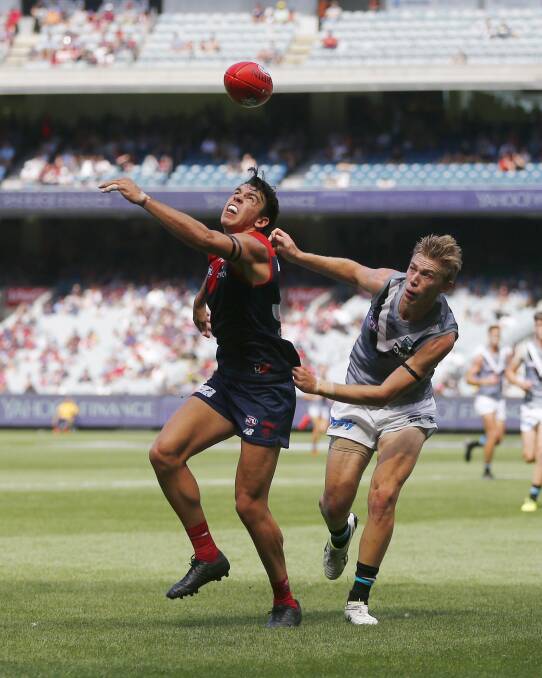 Marty Hore tries to win possession of the ball against Port Adelaide.