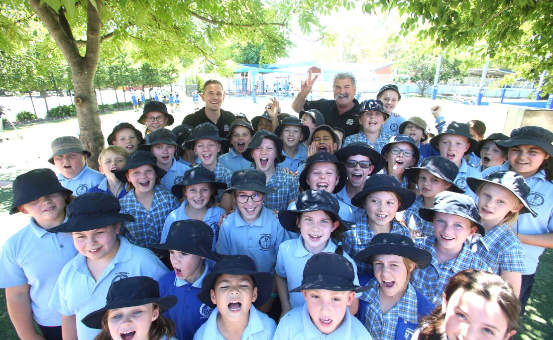 Joel Selwood and Robert Dipierdomenico at St Monica's Primary School in Kangaroo Flat to launch the Cloud Copy Click Premiership Schools program. Picture: GLENN DANIELS