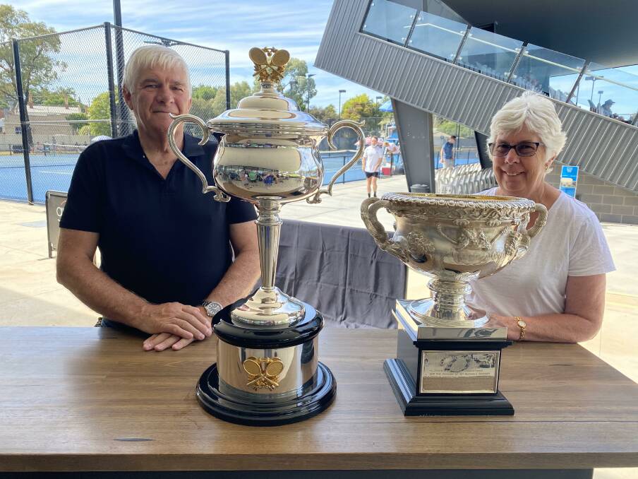 SLAM: Eric Smith and Mary Murphy with the Australian Open women's and men's trophies. Picture: LUKE WEST