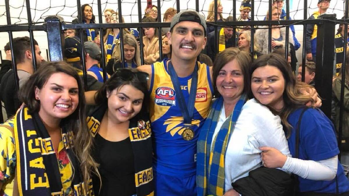Tom Cole is embraced in the West Coast rooms by his mother Donna and three sisters Brittany, Gabrielle and Darcey. Picture: COLE FAMILY