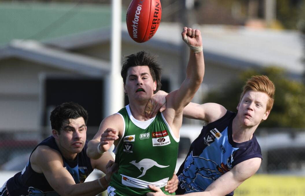 ROO SANDWICH: Kyle Symons clears the ball away from Eaglehawk duo Sam Harper and Gedd Hommelhoff.