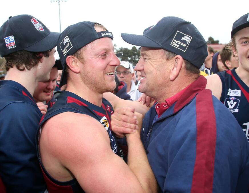 Sandhurst captain Blair Holmes and coach Wayne Primmer embrace after the final siren. Picture: GLENN DANIELS
