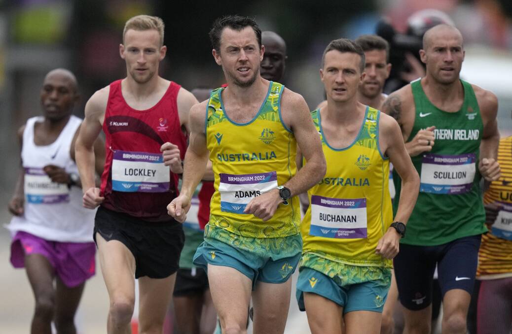 Andy Buchanan, right, in the early stages of the men's marathon. Picture: AAP