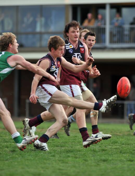 Nick Stagg kicks in front of team-mate Tyson Findlay.