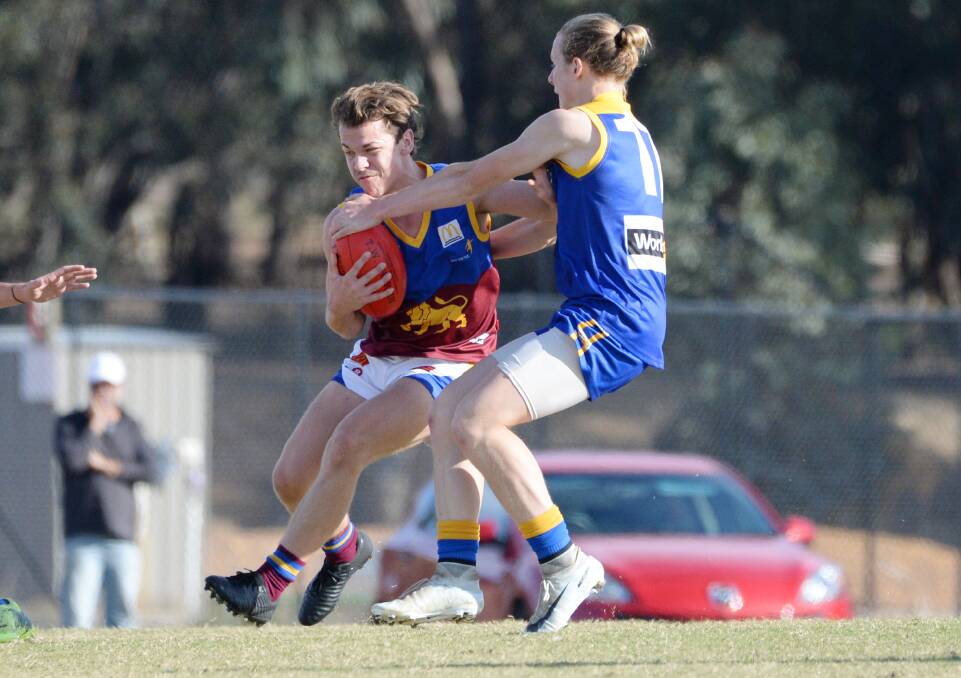 PRESSURE: HDFNL footballer Will Pressnell lays a tackle against MCDFNL.