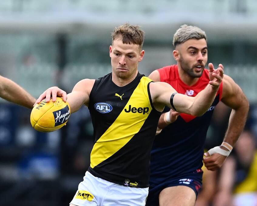 Jake Aarts with his first kick in the AFL against Melbourne at the MCG last Sunday. Picture: GETTY IMAGES