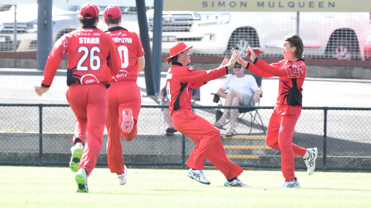 Bendigo United players run to Henry Edwards after his throw from the deep hit the stumps to run out James Barri.
