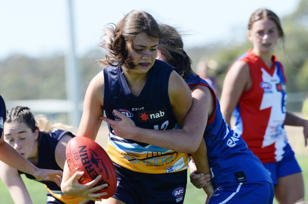 Eliza Bell bursts through a tackle for the Bendigo Pioneers under-18 girls in their win over Gippsland. Picture: DARREN HOWE