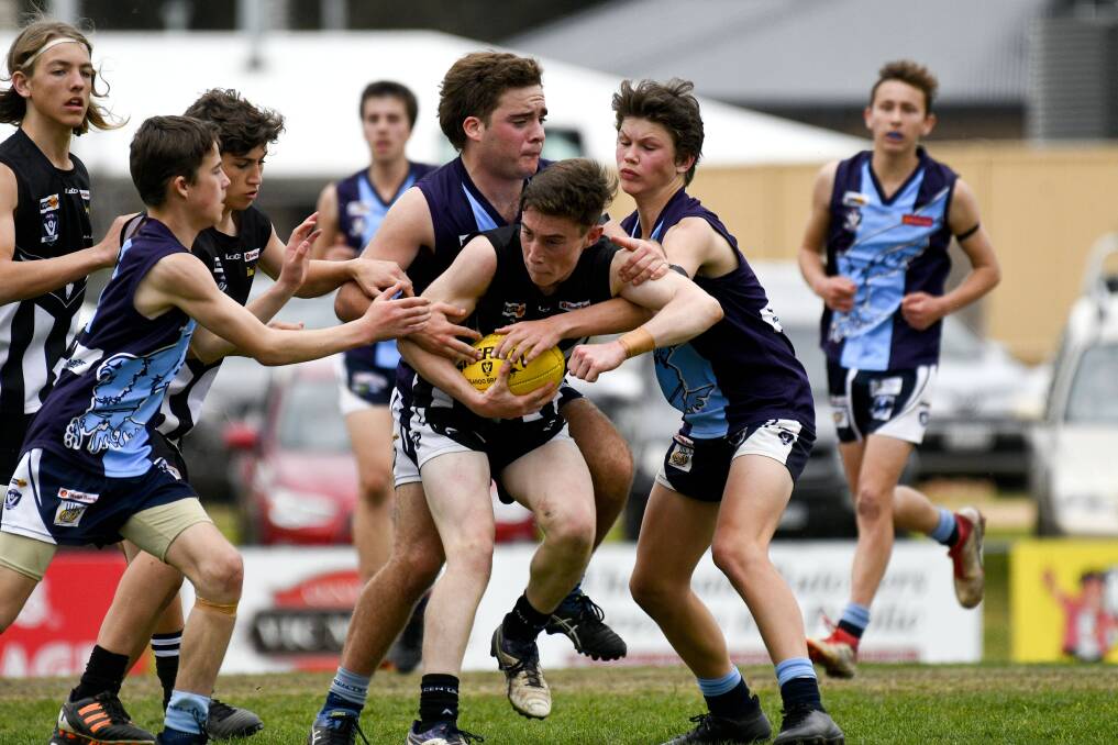 PRESSURE: Action from the Castlemaine versus Eaglehawk under-16 reserves match. Pictures: NONI HYETT
