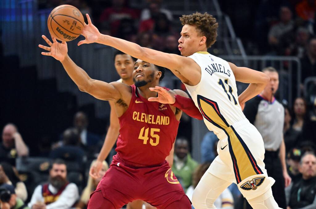 Dyson Daniels knocks the ball clear of Cleveland star Donovan Mitchell in the Pelicans' loss to the Cavs. Picture by Getty Images