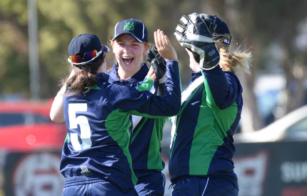 ALL SMILES: Victoria Country players celebrate a wicket against Northern Territory on day one. Picture: DARREN HOWE