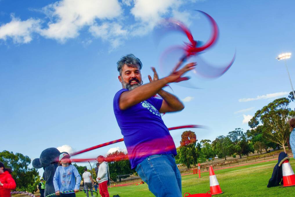 IN A SPIN: Vern Hardie of The Connected Circus performs at Friday night's 5km Frenzy and Summer in the Parks carnival at the Flora Hill Athletics Complex. Picture: BRENDAN McCARTHY