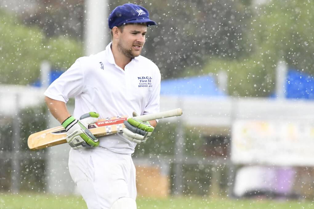 Northern Districts' Sam O'Shea runs off the field after rain stopped play. Picture: NONI HYETT