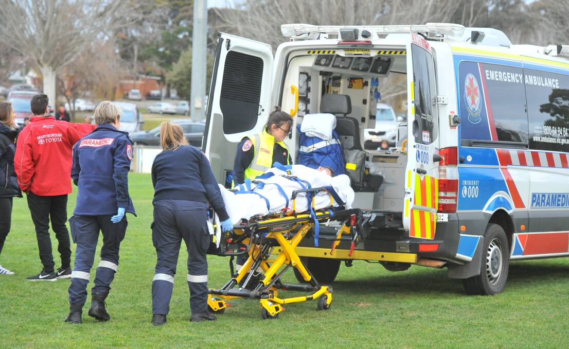 Maryborough's Ash Noonan is loaded into the back of an ambulance after being knocked out against Castlemaine. Picture: ADAM BOURKE