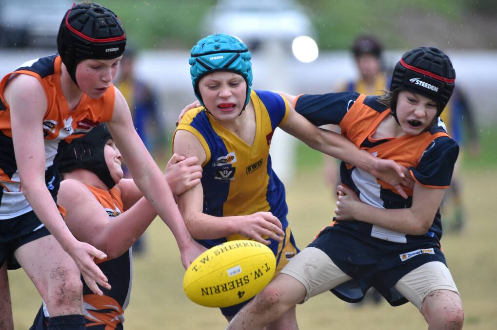 CONTEST: Maiden Gully YCW and Golden Square players battle for the ball in their under-12A game on Saturday. Picture: GLENN DANIELS