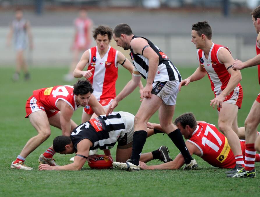 South Bendigo and Castlemaine players battle for the ball at the QEO. 