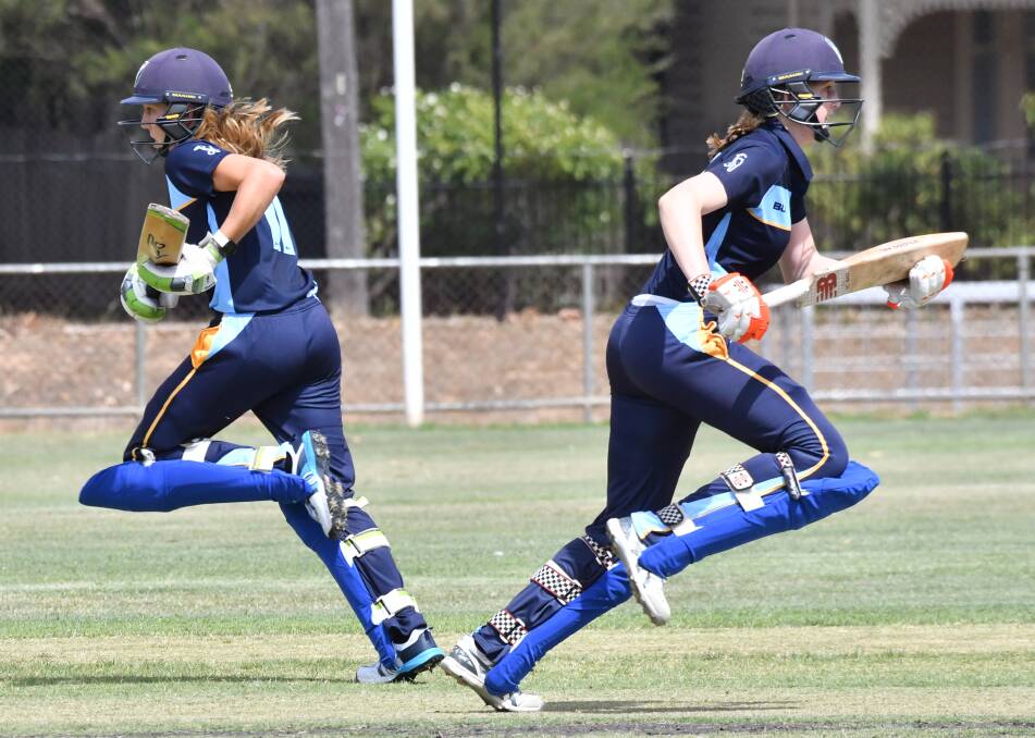 MIRROR IMAGES: Anika Learoyd and Sarah Young  run hard between wickets for ACT/NSW Country. Picture: DARREN HOWE
