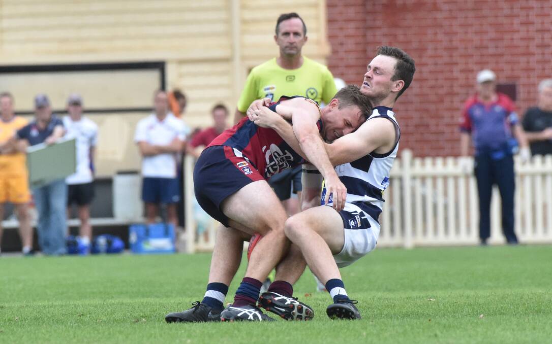 Storm's James Schischka tackles Sandhurst's Jake McLean in the Good Friday game at the QEO. Pictures: NONI HYETT