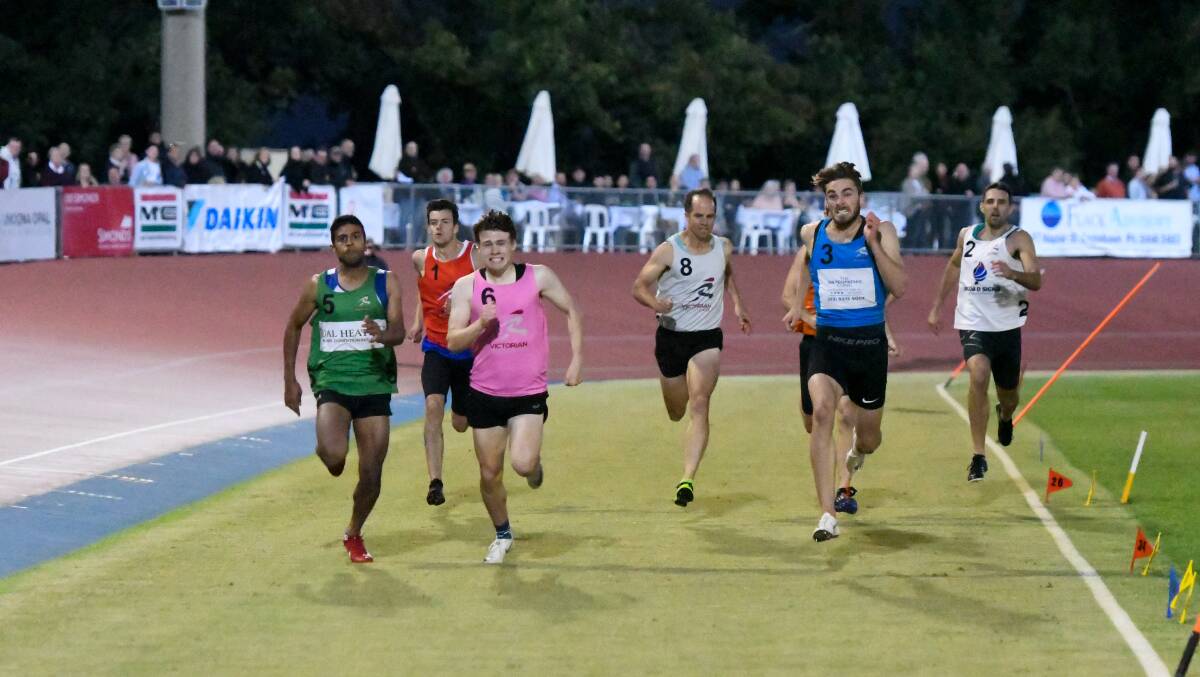 Lucas Wright (pink) sprints to the finish line of the Black Opal 400m final. Picture: NONI HYETT