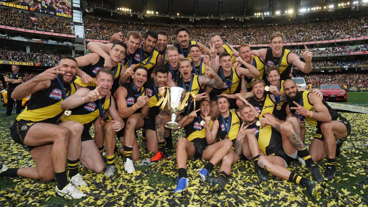 Dustin Martin front and centre with the premiership cup and his Richmond team-mates. Picture: THE AGE