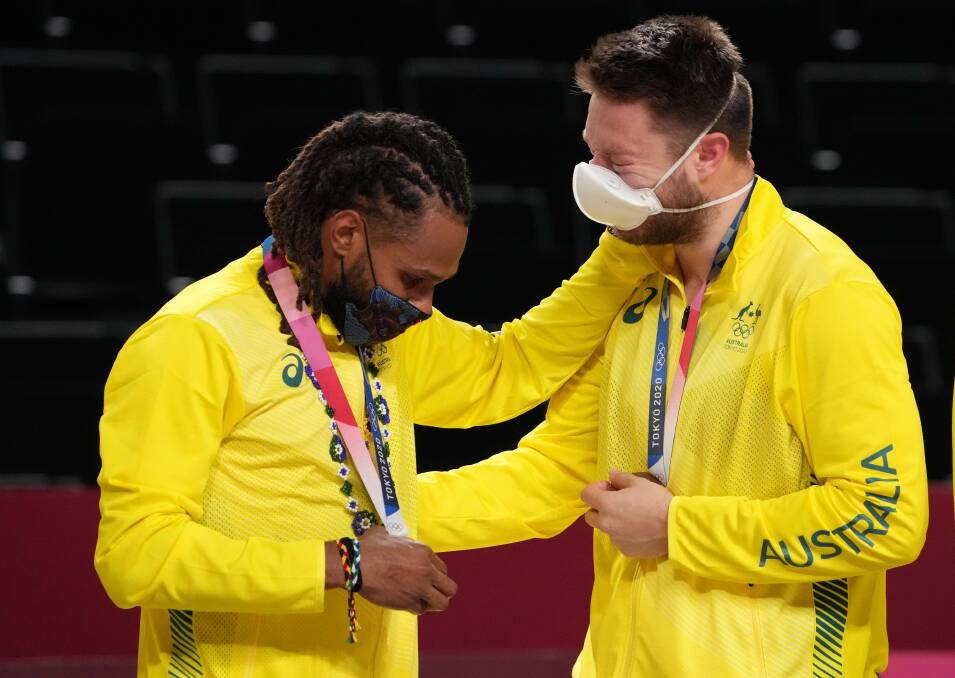 BOOMERS' GREATS: Patty Mills and Matthew Dellavedova share the joy of an Olympic bronze medal. Picture: AAP