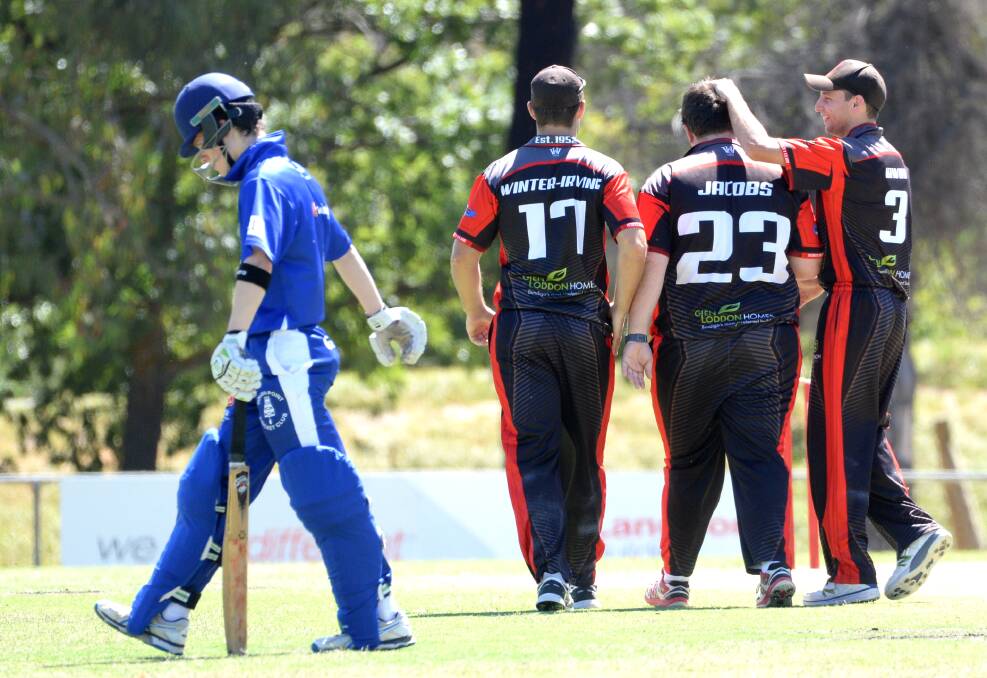 Mitch Winter-Irving and Rhys Irwin congratulate Linc Jacobs after he took one of his five wickets. Picture: DARREN HOWE