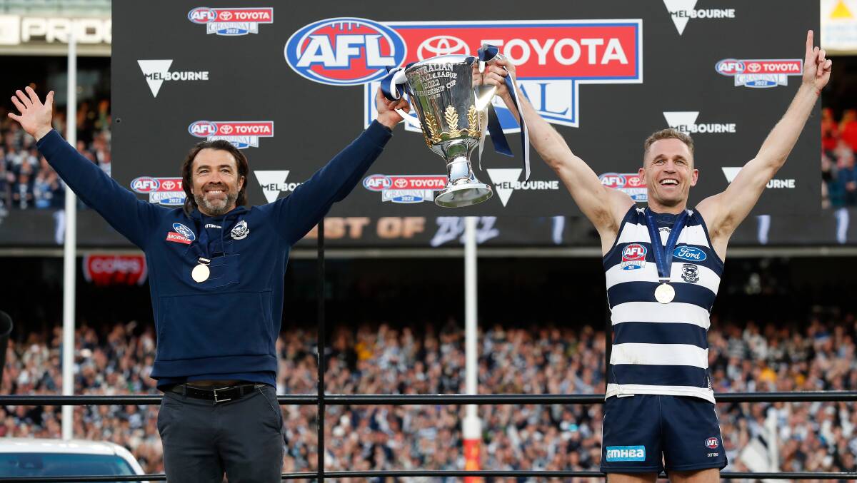 Chris Scott and Joel Selwood lift the AFL premiership cup. Picture by Getty Images