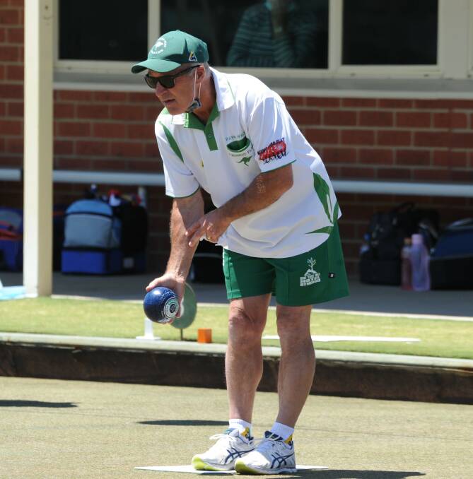 Wayne Walsh concentrates before playing a bowl for the Roos.
