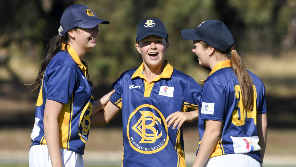 HAVING A BALL: Bendigo's Amy Ryan, Lila Keck and Holly Ryan were all smiles in the field against Sandhurst. Picture: NONI HYETT