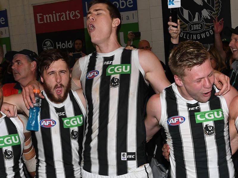 Mason Cox (c) is enjoying life with his AFL teammates at grand finalists Collingwood.